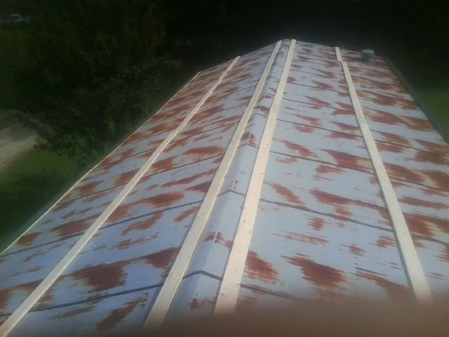 Rusted metal roof panels with new wood purlins before replacement — Storm Damage Roof Repair in Ranchita by Roofing Brothers