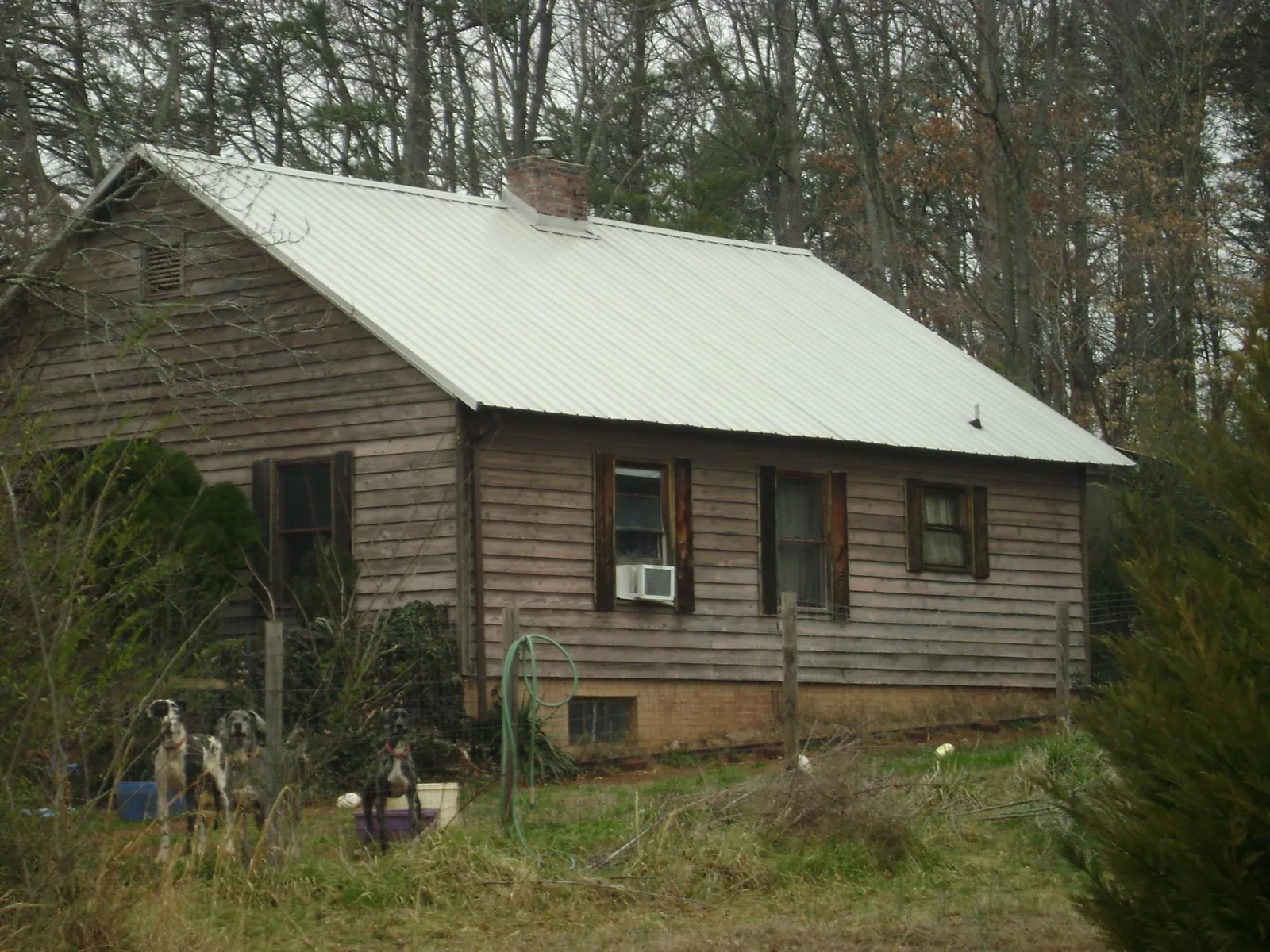 White metal roof on an old wood sided farmhouse, from a Asphalt Shingle Roof Repair job in Ranchita
